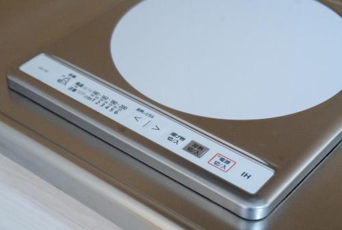 a close up of a remote control on a table at Tokyo Modern Stay Shinjuku in Tokyo