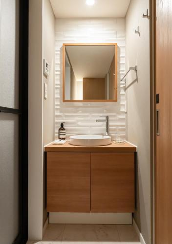 a bathroom with a sink and a mirror at Tokyo Modern Stay Shinjuku in Tokyo