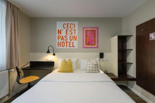 a hotel room with a bed and a chair at SleepinRoomz Boutique Hotel in Dortmund