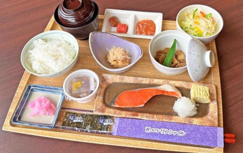 a tray of food with sushi and other food items at Hotel Sunshine in Engaru