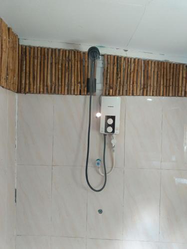 a shower in a bathroom with a hose at Sunny Bungalow in Koh Rong Sanloem