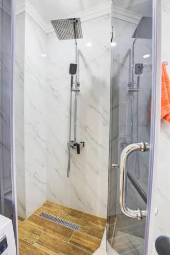 a shower with a glass door in a bathroom at Coco Chanel Apartment in Bishkek in Bishkek