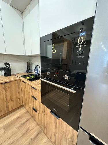 a kitchen with a black stove top oven at Coco Chanel Apartment in Bishkek in Bishkek