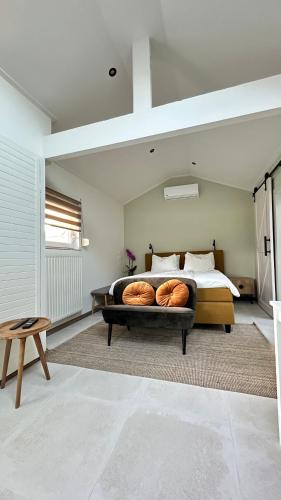 a bedroom with a bed with two donuts on it at Slapen bij de Zeeuwse Lala in IJzendijke