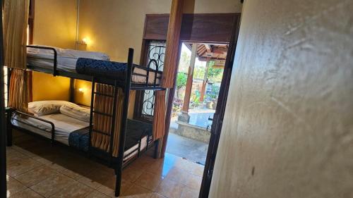a room with two bunk beds and a doorway at Mai Family Guest House in Singaraja