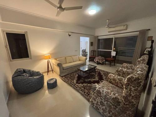 a living room with a couch and chairs and a table at The Grand Ganga, Peaceful, Homely, Near Sangam in Prayagraj
