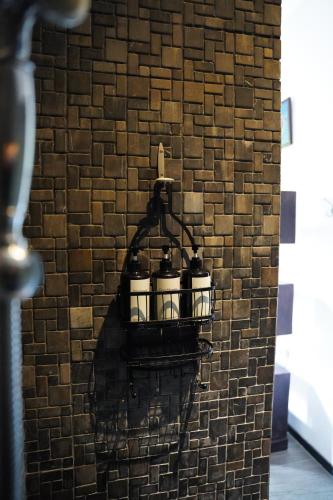 a brick wall with three jars on a shelf at Villa Gita Segara Candidasa in Candidasa