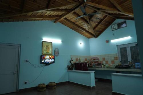 a blue room with a tv on a wall at Dream Stay in Bhīm Tāl