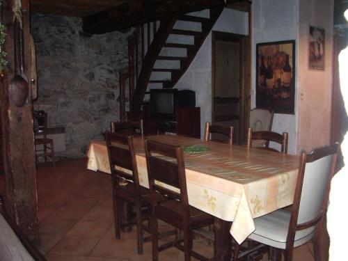 a dining room with a wooden table and chairs at Bergerie authentique au cœur des Pyrénées in Eaux-Bonnes