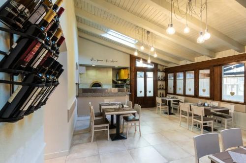 a dining room with tables and chairs in a restaurant at Locanda Romana in Fanano
