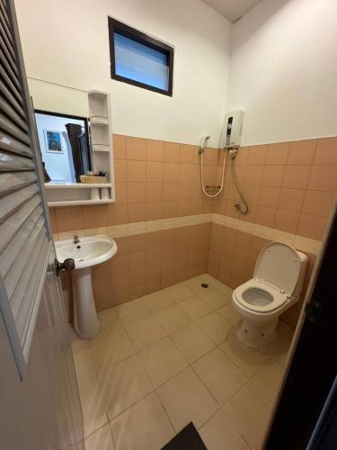 a bathroom with a toilet and a sink at New! MATA Garden resort Ao Nang in Ao Nang Beach