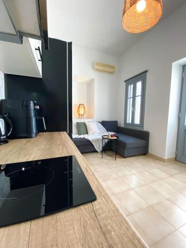 a kitchen and living room with a couch in a room at Artemonas White Escape in Sifnos