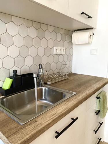 a kitchen with a stainless steel sink in a kitchen at Artemonas White Escape in Sifnos