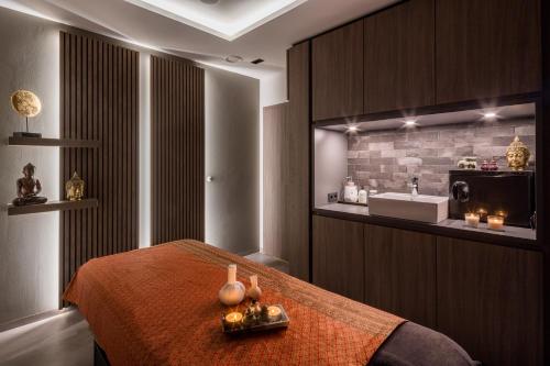 a bedroom with a bed and a sink in a room at Romantik Hotel Ahrenberg in Bad Sooden-Allendorf
