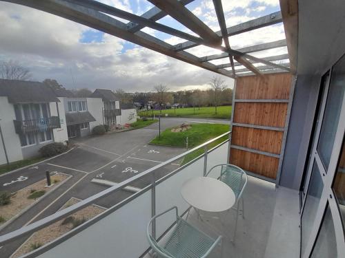 a balcony with chairs and a view of a street at The Originals City, Ara Hôtel, Landerneau in Landerneau