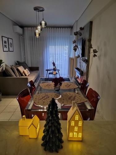 a dining room table with a christmas tree on it at The cozy seaside apartment in Nafpaktos