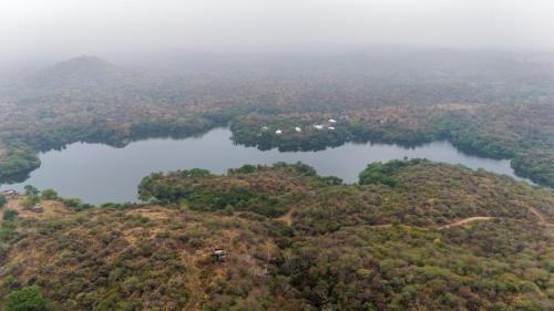 an aerial view of two lakes on a hill at Dera Baghdarrah Nature Retreat Udaipur in Udaipur