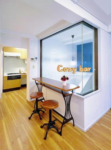 a room with a table and two stools and a window at Easily to Nishi-Nippori Shibuya Asakusa For 10 in Tokyo