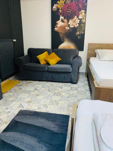a living room with a couch and a painting of a woman at Rooms & Apartment ZALA in Cerklje na Gorenjskem