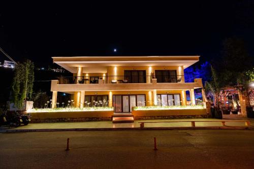 a large building with lights in front of it at night at Blue Sea Suites in Afitos