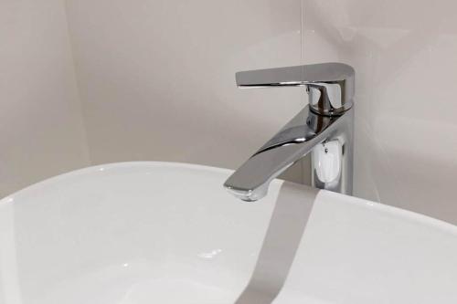 a sink in a bathroom with a faucet at Blue Sea Suites in Afitos