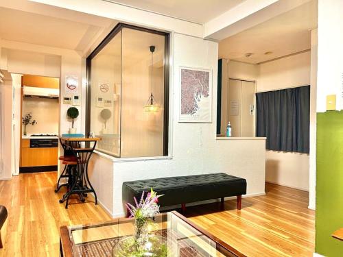 a living room with a bench and a table at Easily to Nishi-Nippori Shibuya Asakusa For 10 in Tokyo