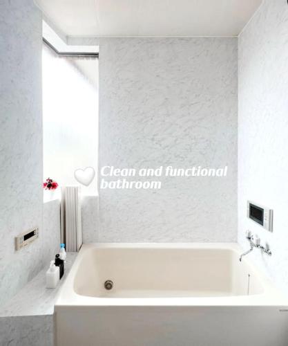 a white bath tub in a white bathroom at Easily to Nishi-Nippori Shibuya Asakusa For 10 in Tokyo