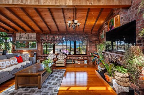a living room with a couch and a table at Red Brick Seaview Lof,Green Oasis,Massage in Kingston Beach