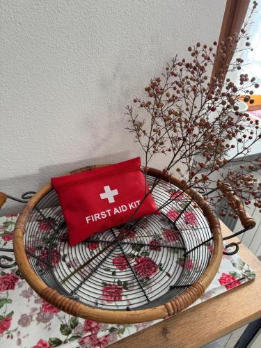 a basket with a first aid box on top of it at Casa Margherita in San Pellegrino Terme