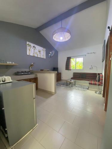 a kitchen and living room with a blue ceiling at Oasis club in Cap Skirring