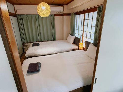 Postel nebo postele na pokoji v ubytování Tokyo Shinjuku Waseda House新宿早稲田