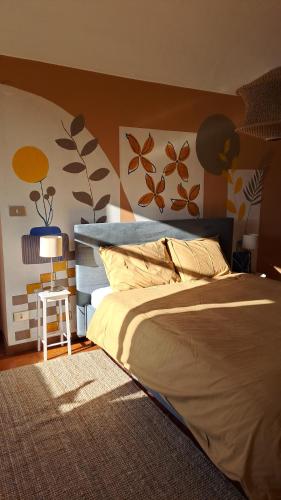 a bedroom with a bed and a table with a lamp at CasaTraVigne in Brusnengo