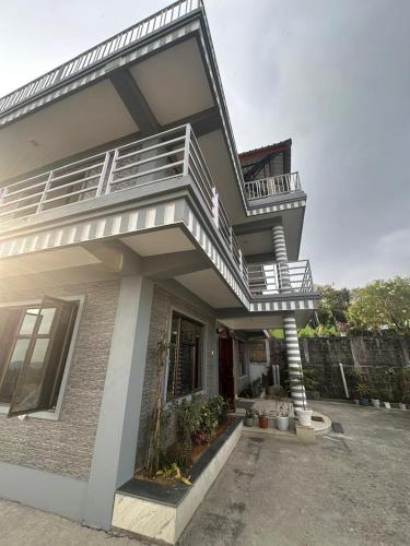 a house with a staircase on the side of it at Odyssey Stays Nongrim, Cherrapunji in Cherrapunji