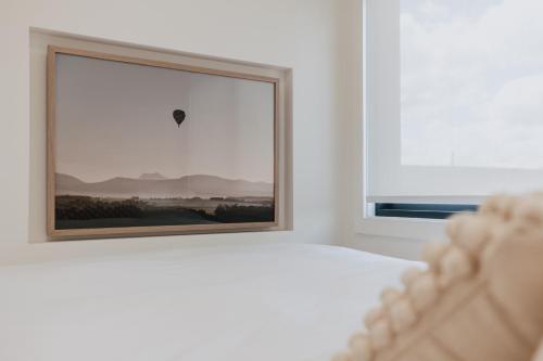 a bedroom with a bed and a window with a hot air balloon at Tiny Home in Scottsdale in Scottsdale