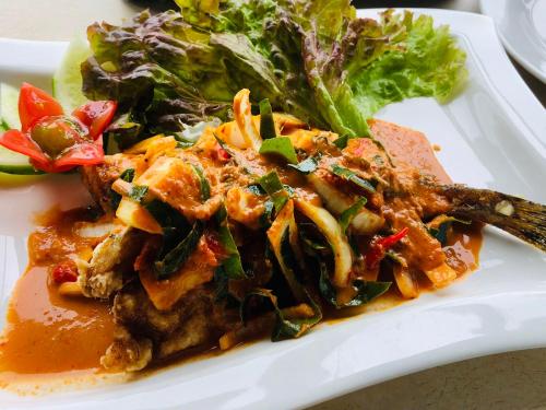 a plate of food with a salad on a table at Onomichi View Hotel Seizan in Onomichi