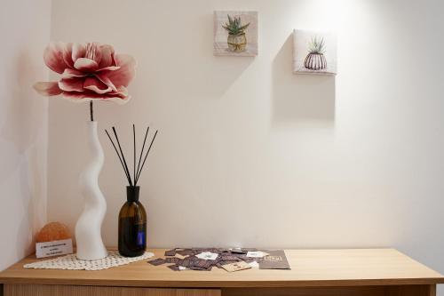 a table with a vase and a flower on it at CIVICO 15 BED BREAKFAST in Mercato San Severino
