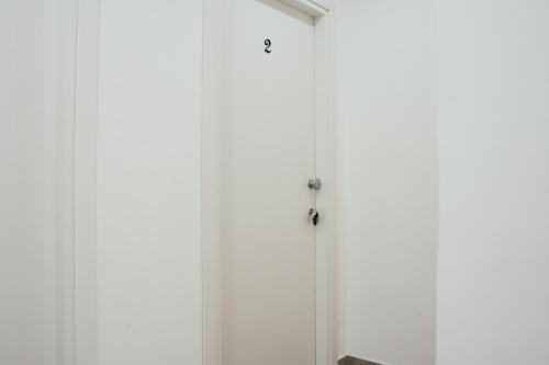 a room with white walls and a door at CIVICO 15 BED BREAKFAST in Mercato San Severino