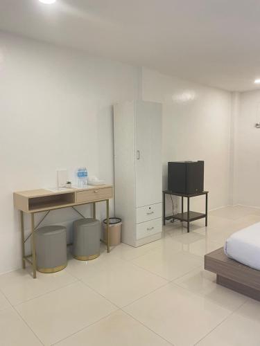 a bedroom with a desk and a bed and a desk with a computer at HOTEL the MIR in Lapu Lapu City