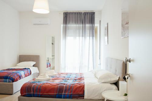 a bedroom with two beds and a window at CIVICO 15 BED BREAKFAST in Mercato San Severino