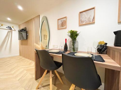 a dining room with a table and two chairs at Suite Émeraude centre ville in Sélestat