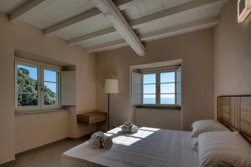 a bedroom with two beds and two windows at Campetti Apartments in Vesima