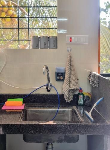 a kitchen sink with a faucet on a counter at Your perfect high standart cosy Home near Arambol with 2BHK in Arambol