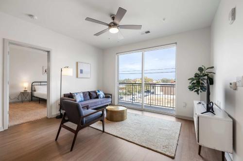 a living room with a couch and a window at Modern Nulu 2BR CozySuites 08 in Louisville
