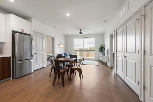 a kitchen and dining room with a table and chairs at Modern Nulu 2BR CozySuites 08 in Louisville