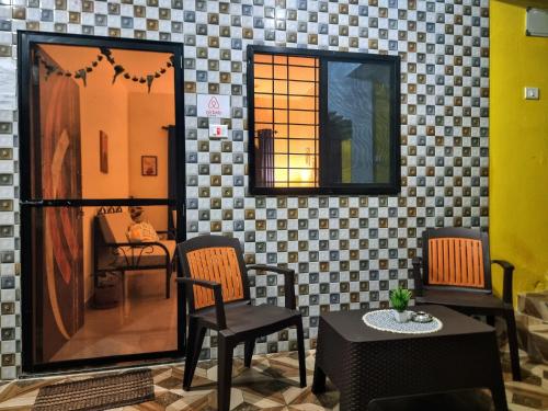 a room with two chairs and a table and a mirror at Your perfect high standart cosy Home near Arambol with 2BHK in Arambol