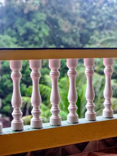 a wooden rail on a balcony with a window at Your perfect high standart cosy Home near Arambol with 2BHK in Arambol