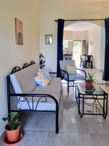 a living room with two beds and a table at Your perfect high standart cosy Home near Arambol with 2BHK in Arambol