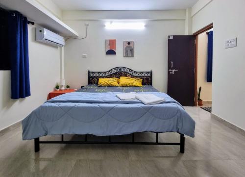 a bedroom with a large bed with a blue blanket at Your perfect high standart cosy Home near Arambol with 2BHK in Arambol
