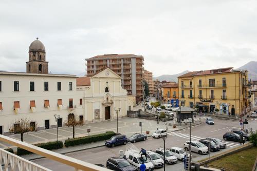 a city with cars parked in a parking lot at CIVICO 15 BED BREAKFAST in Mercato San Severino
