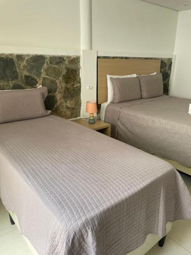 Katil atau katil-katil dalam bilik di Suites Amma Noronha